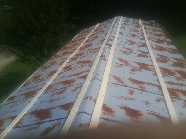 Rusted metal roof panels with new wood purlins before replacement — Storm Damage Roof Repair in Beech Island by Roofing Brothers