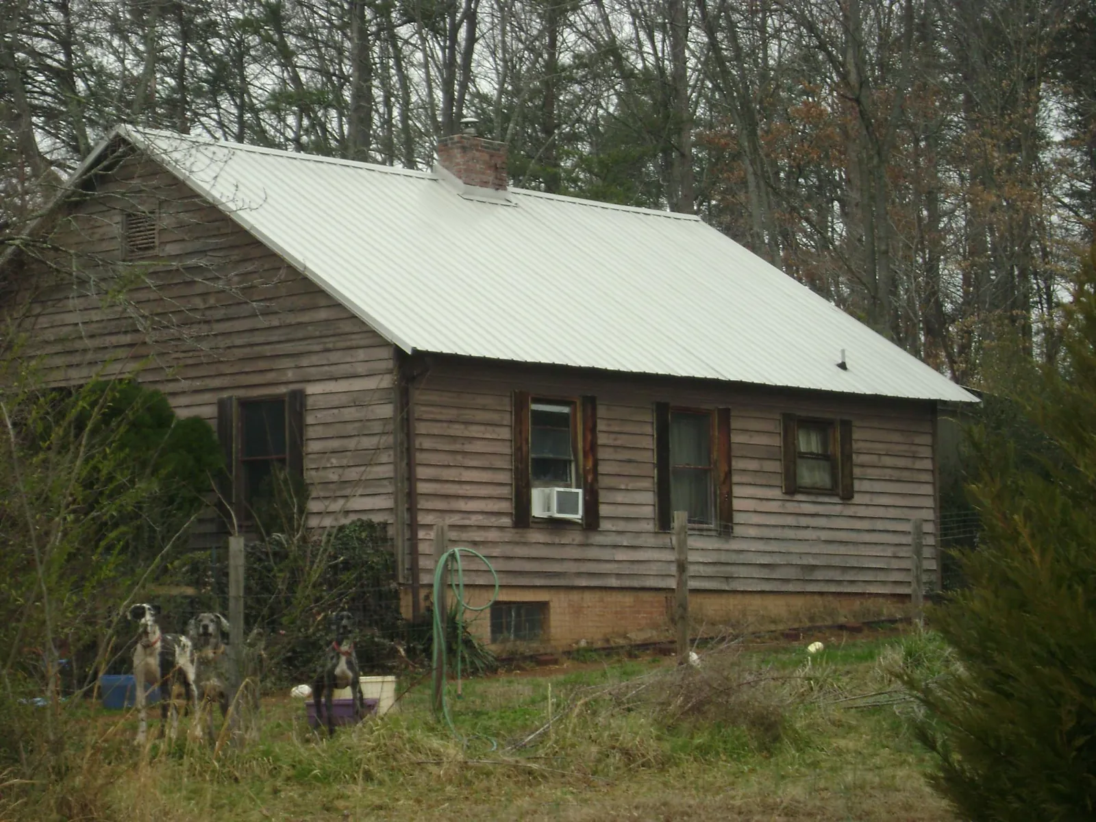 White metal roof on an old wood sided farmhouse, from a Metal Roof Installation job in Beech Island
